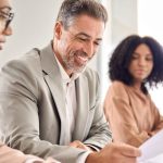 A successful attorney reviewing financial projections and lead reports in a modern office, representing lawyers scaling to $500K+ in income.