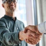 Lawyer sealing a high-value client deal with a handshake, symbolizing how to make $300K a year as a lawyer