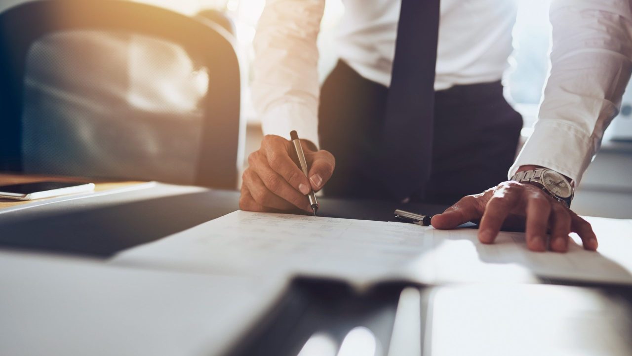 Lawyer in a high-end office reviewing revenue reports and client growth strategies