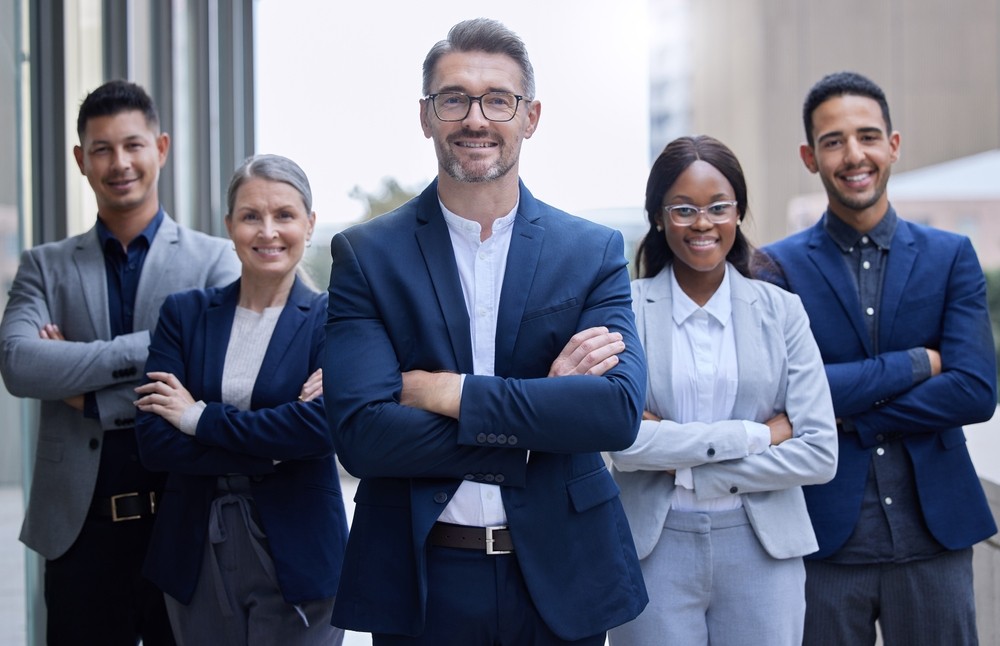 Professional business team standing confidently with arms crossed