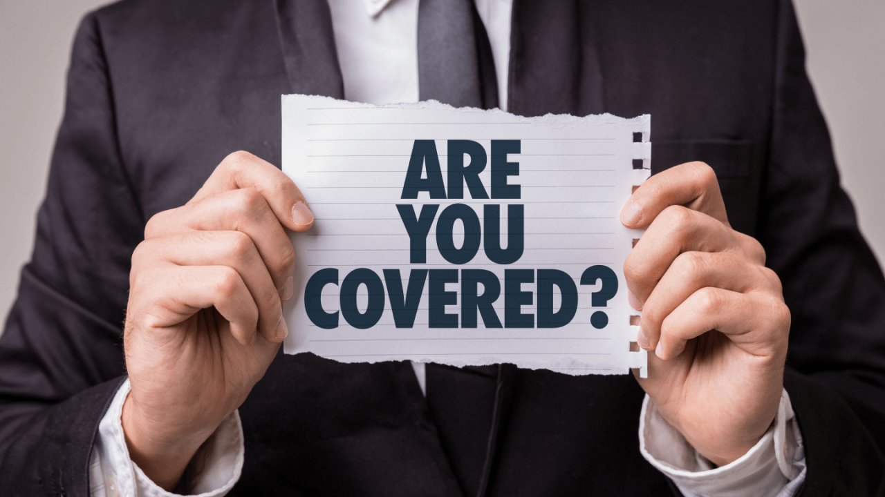 Businessman holding a sign that reads “Are You Covered?”