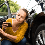 Woman inspecting car dent with phone — how do I get a quote for car damage?