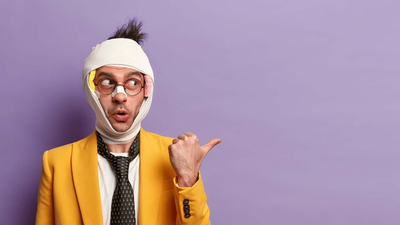Confused man with bandages pointing sideways — how do you get a car after a car accident