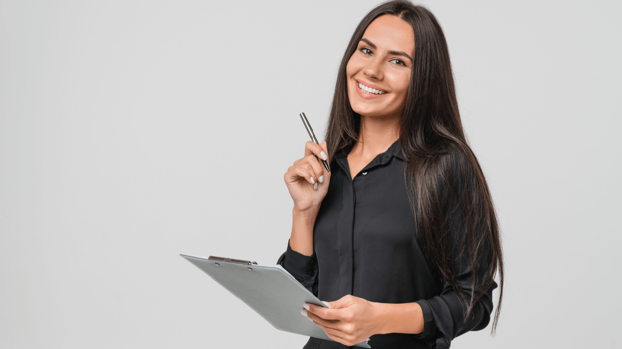 Woman holding clipboard and pen, representing how leads work in insurance