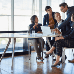 Business team discussing strategy around laptop – what are HQL leads