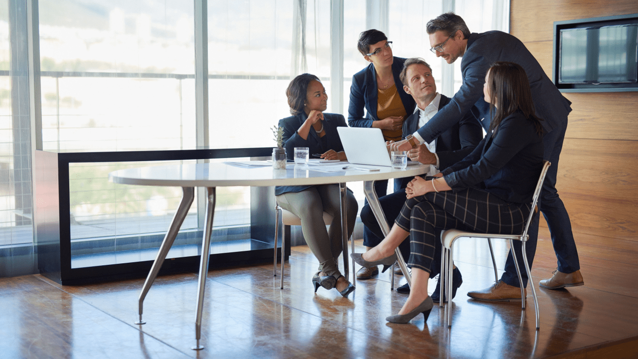 Business team discussing strategy around laptop – what are HQL leads