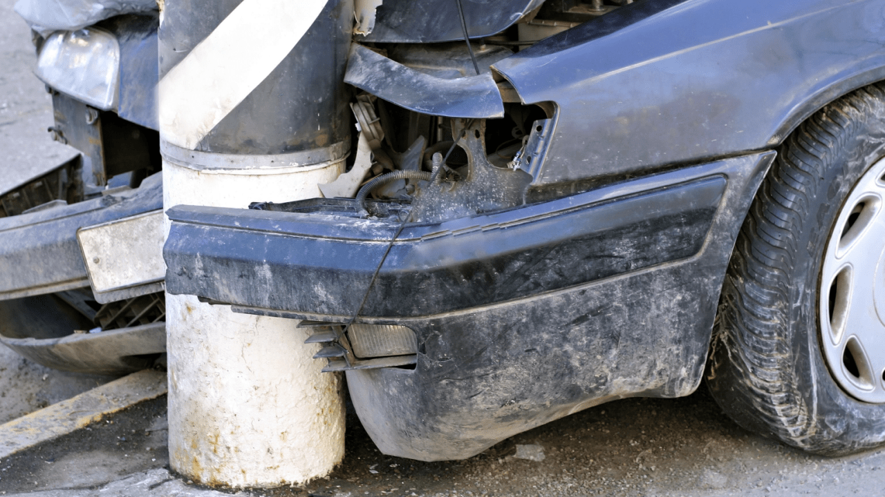 Close-up of a car with front-end damage after hitting a pole – should I file a claim if I hit a pole