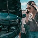 Frustrated woman calling for help beside her broken-down vehicle – what happens when you hit one of your own cars