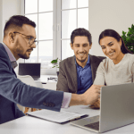 Financial advisor discussing bankruptcy options with a smiling couple during a consultation.