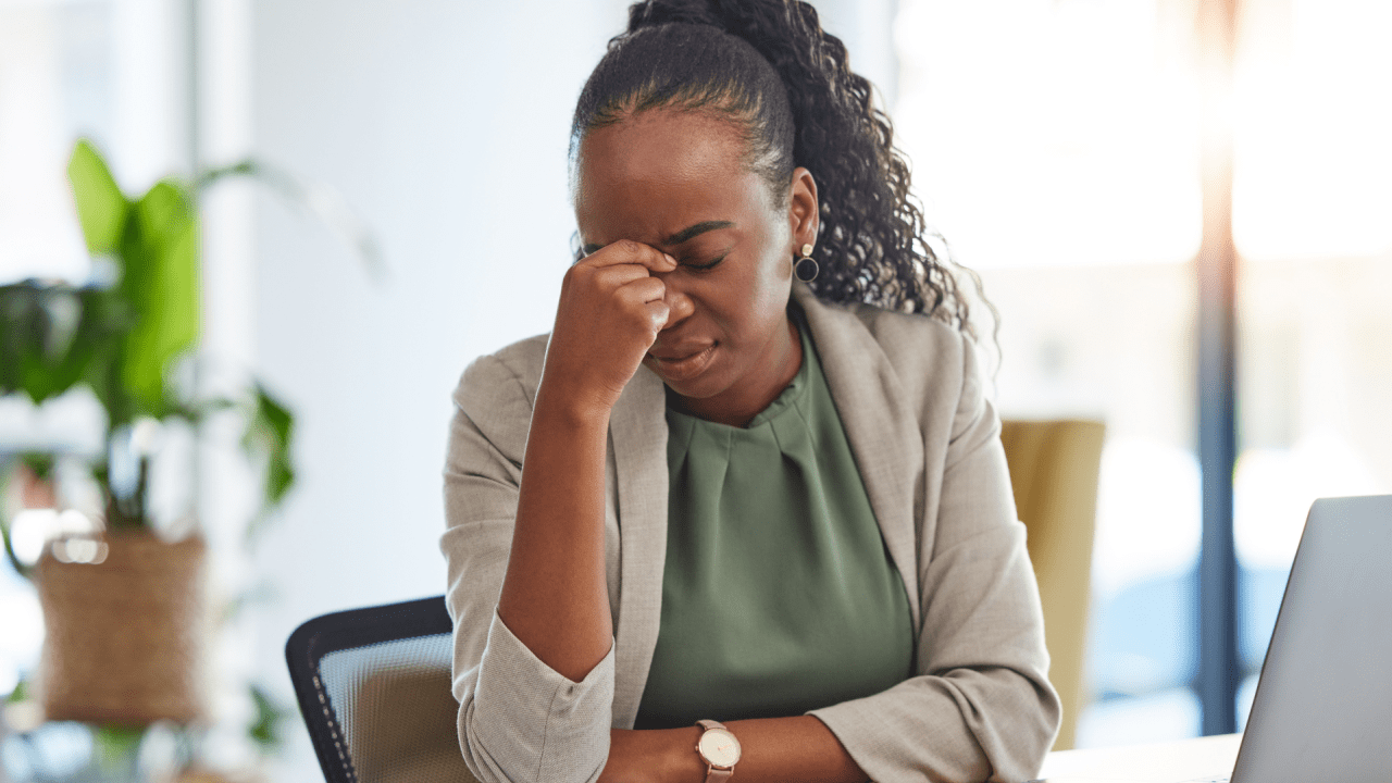 Stressed professional woman with hand on forehead showing concern about potential bankruptcy failure and legal complications