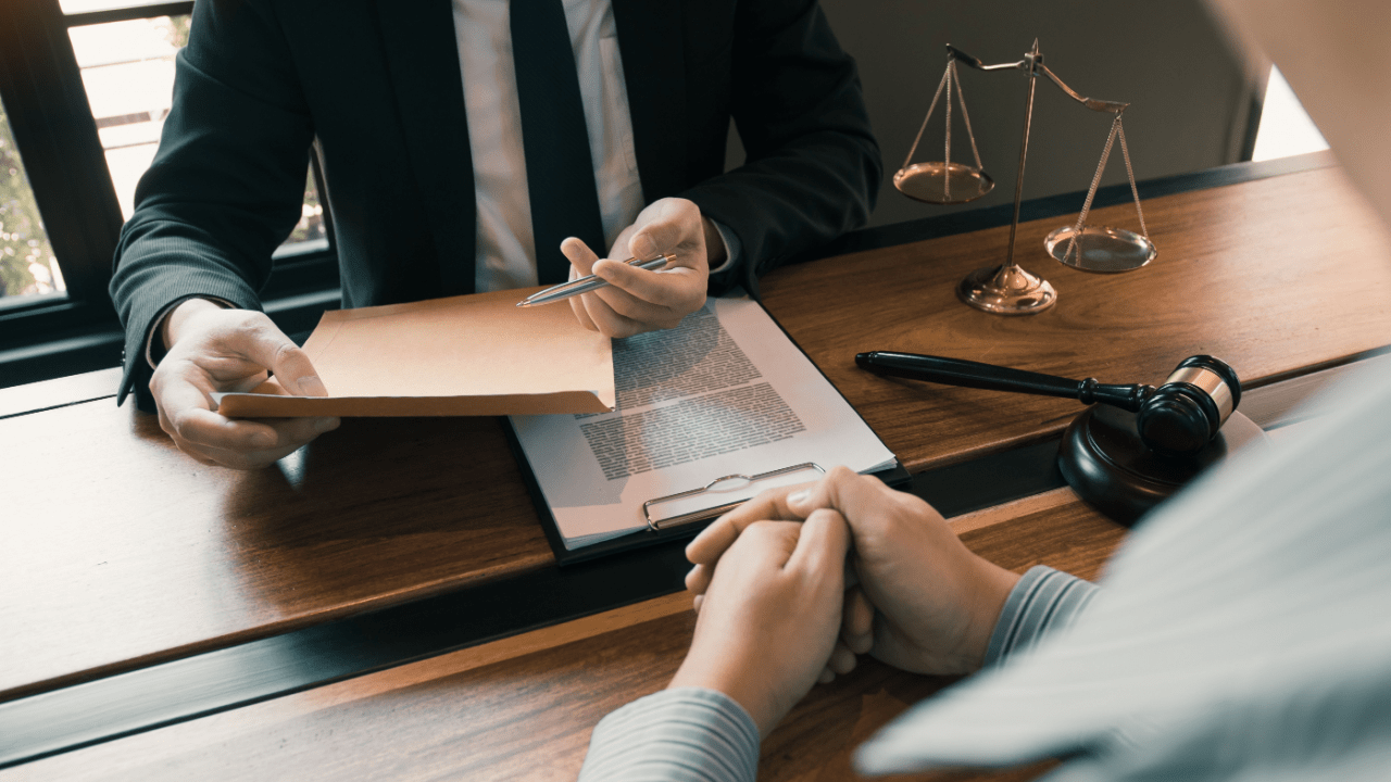 Client consulting with Chapter 13 bankruptcy attorney at law office, discussing whether you need an attorney for Chapter 13 filing with legal documents and scales of justice