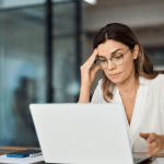 Concerned woman researching financial options on her laptop, trying to understand what disqualifies you from filing bankruptcies.