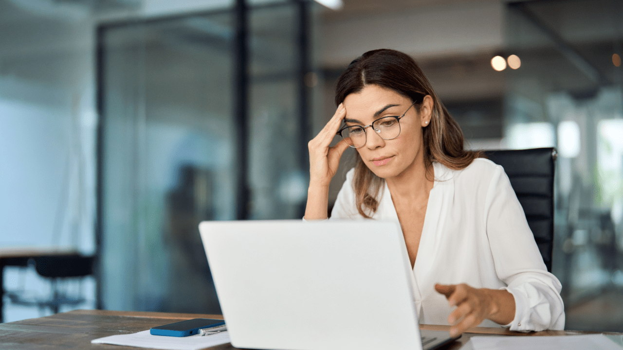 Concerned woman researching financial options on her laptop, trying to understand what disqualifies you from filing bankruptcies.