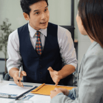 Attorney consulting with client while considering how long should law firm blog posts be for SEO content strategy