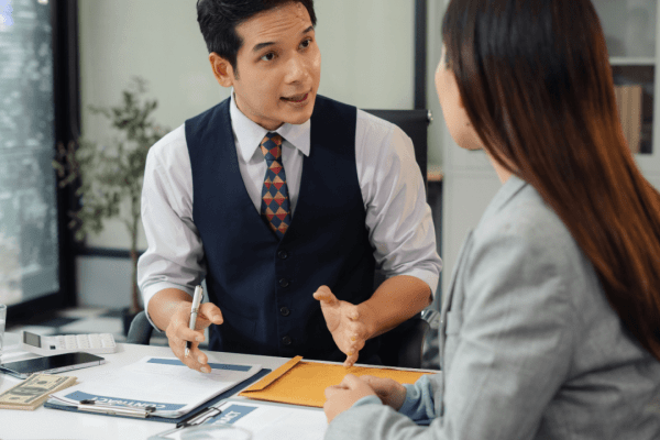 Attorney consulting with client while considering how long should law firm blog posts be for SEO content strategy