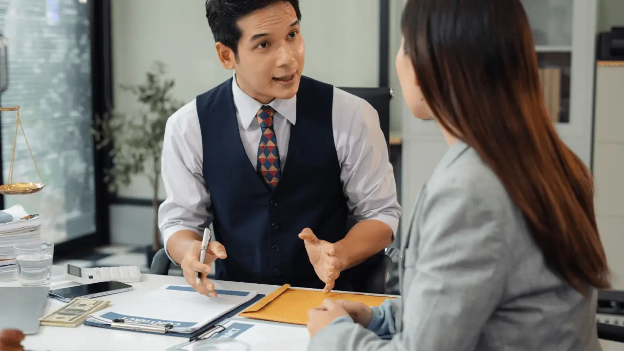 Attorney consulting with client while considering how long should law firm blog posts be for SEO content strategy