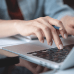 Legal professional typing on laptop learning how to choose SEO keywords for law firm website