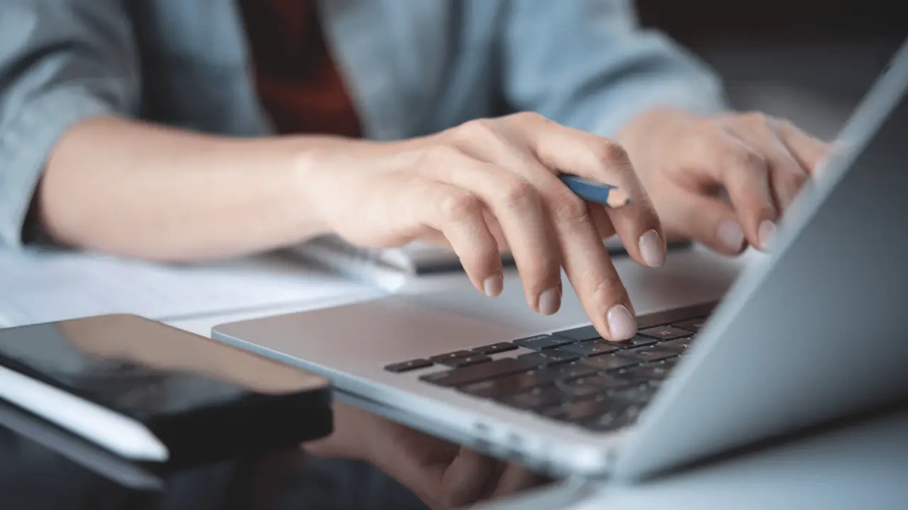 Legal professional typing on laptop learning how to choose SEO keywords for law firm website