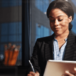 Attorney reviewing digital analytics on tablet learning how to improve law firm SEO in modern office setting