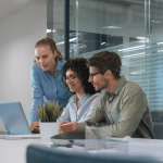 Marketing team comparing law firm SEO vs PPC which is better while reviewing digital strategy options on laptops in conference room
