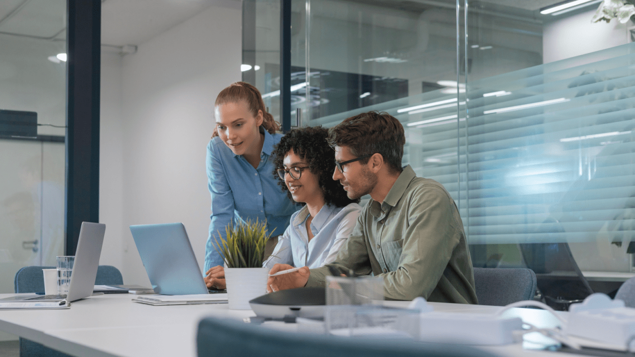 Marketing team comparing law firm SEO vs PPC which is better while reviewing digital strategy options on laptops in conference room