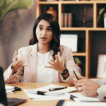 Woman discussing average price of bankruptcy leads during business meeting with financial advisors