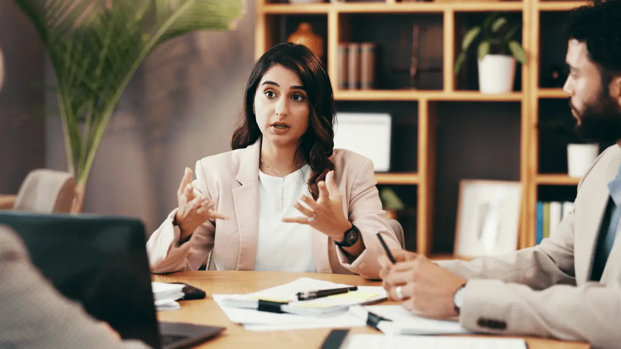 Woman discussing average price of bankruptcy leads during business meeting with financial advisors