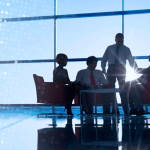 Executive legal team meeting in high-rise office discussing what are some effective law firm SEO strategies