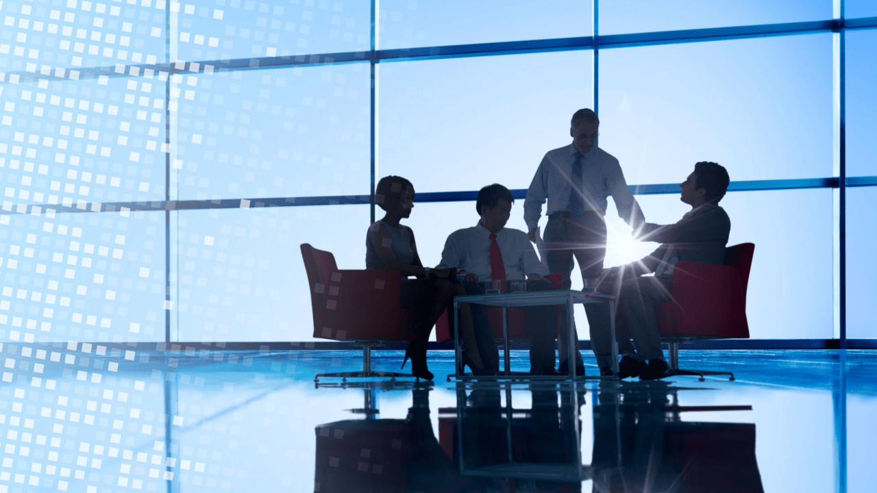 Executive legal team meeting in high-rise office discussing what are some effective law firm SEO strategies