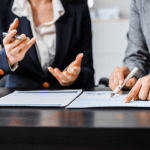 Two attorneys discussing what is the role of backlinks in law firm SEO while reviewing analytics and documents with gavel on desk