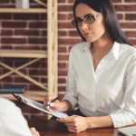 Professional consultant explaining cost of exclusive bankruptcy leads to client during one-on-one meeting