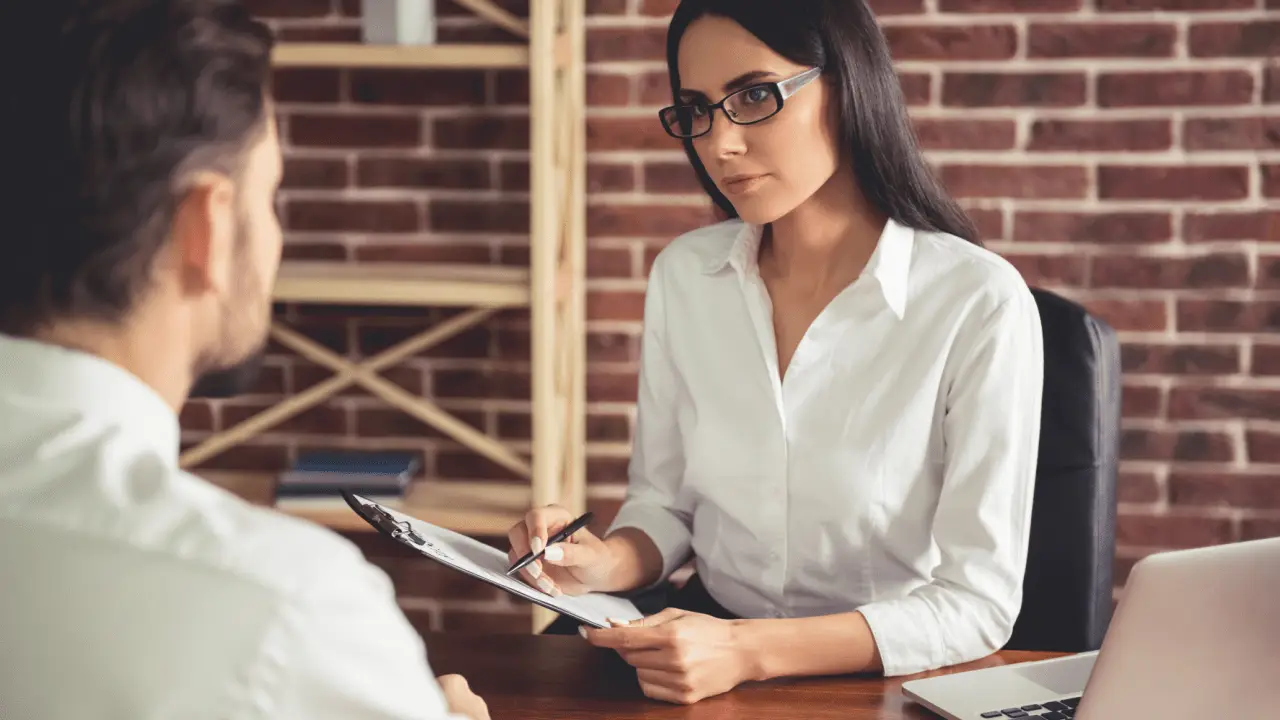 Professional consultant explaining cost of exclusive bankruptcy leads to client during one-on-one meeting