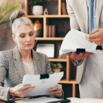 Auto accident lawyer reviewing case documents with client during consultation from exclusive auto accident leads