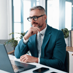 Professional attorney researching what is geotagging and does it help law firm SEO on laptop in modern office