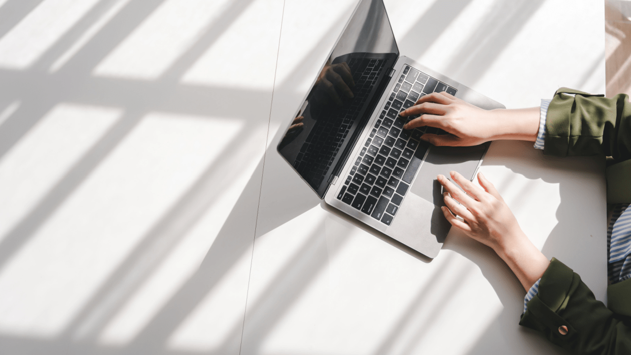 Professional researching options to buy leads for bankruptcy on laptop in bright minimalist workspace