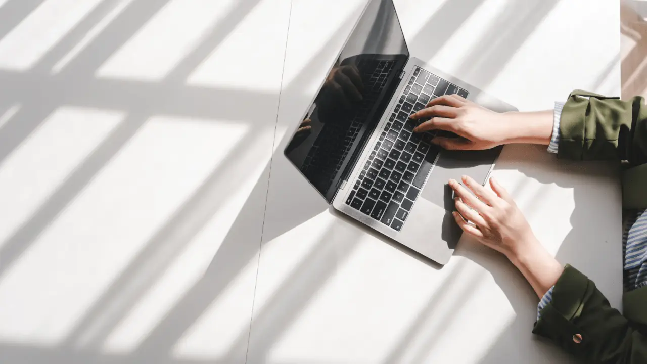 Professional researching options to buy leads for bankruptcy on laptop in bright minimalist workspace