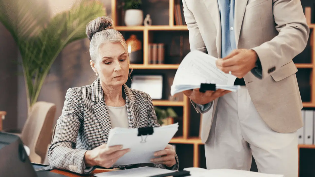 Auto accident lawyer reviewing case documents with client during consultation from exclusive auto accident leads