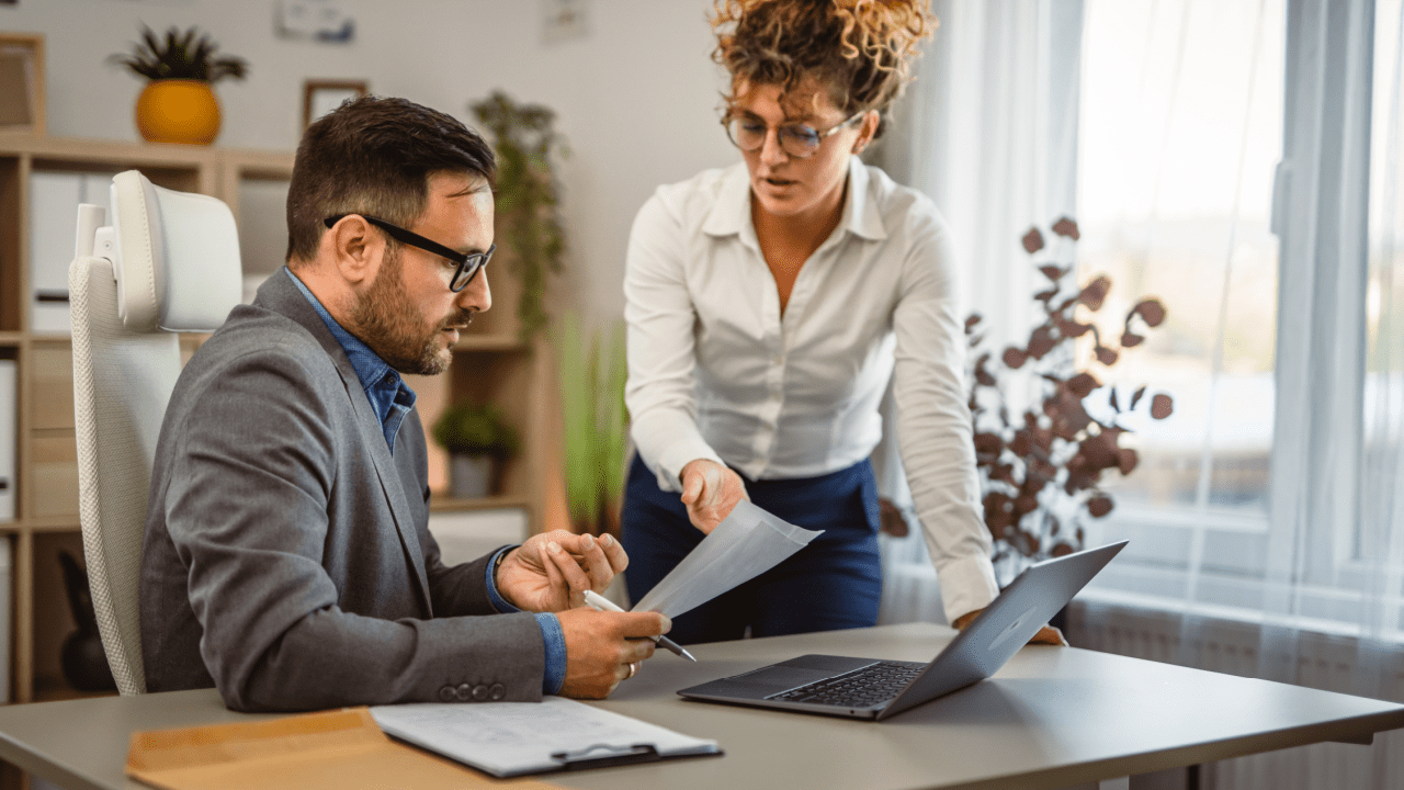 Legal professionals reviewing bankruptcy legal leads and case documents in bright modern office