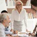 Client acquisition strategy for lawyers team meeting with lead attorney presenting marketing plan to colleagues