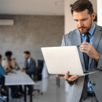 Attorney analyzing conversion optimization for law firms data on laptop in professional office setting