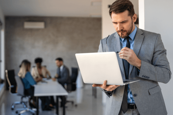 Attorney analyzing conversion optimization for law firms data on laptop in professional office setting