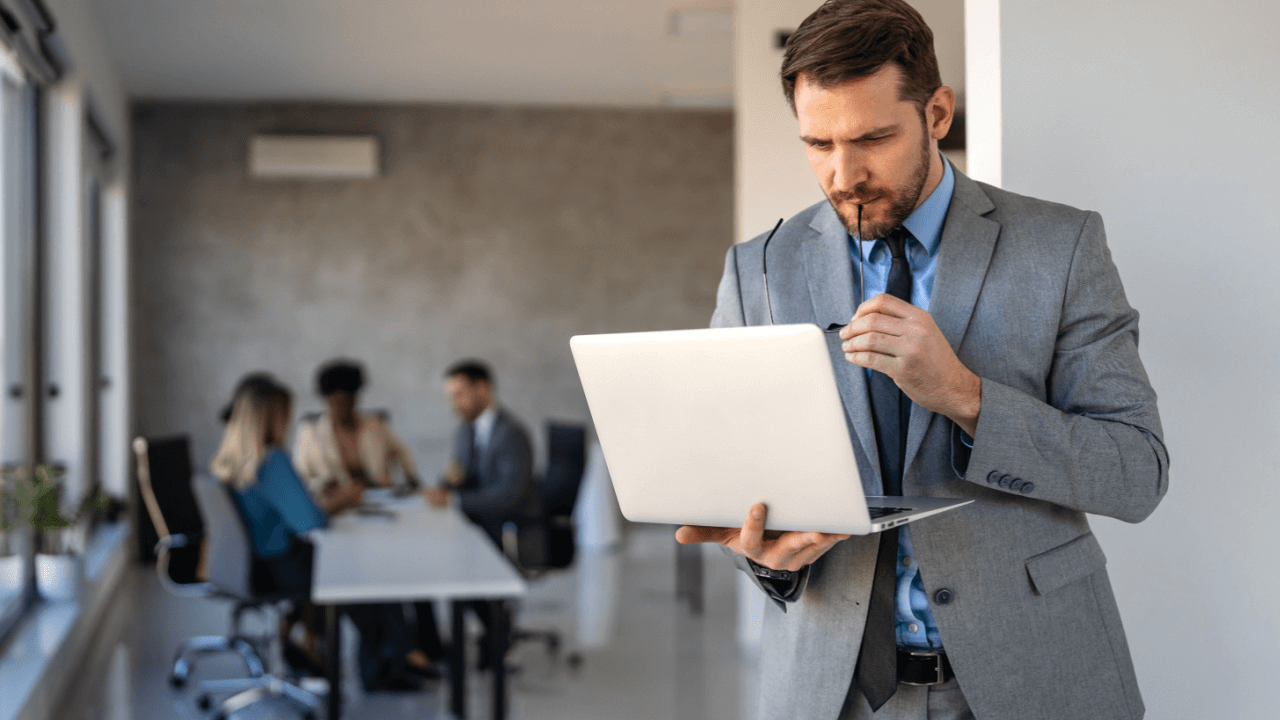 Attorney analyzing conversion optimization for law firms data on laptop in professional office setting