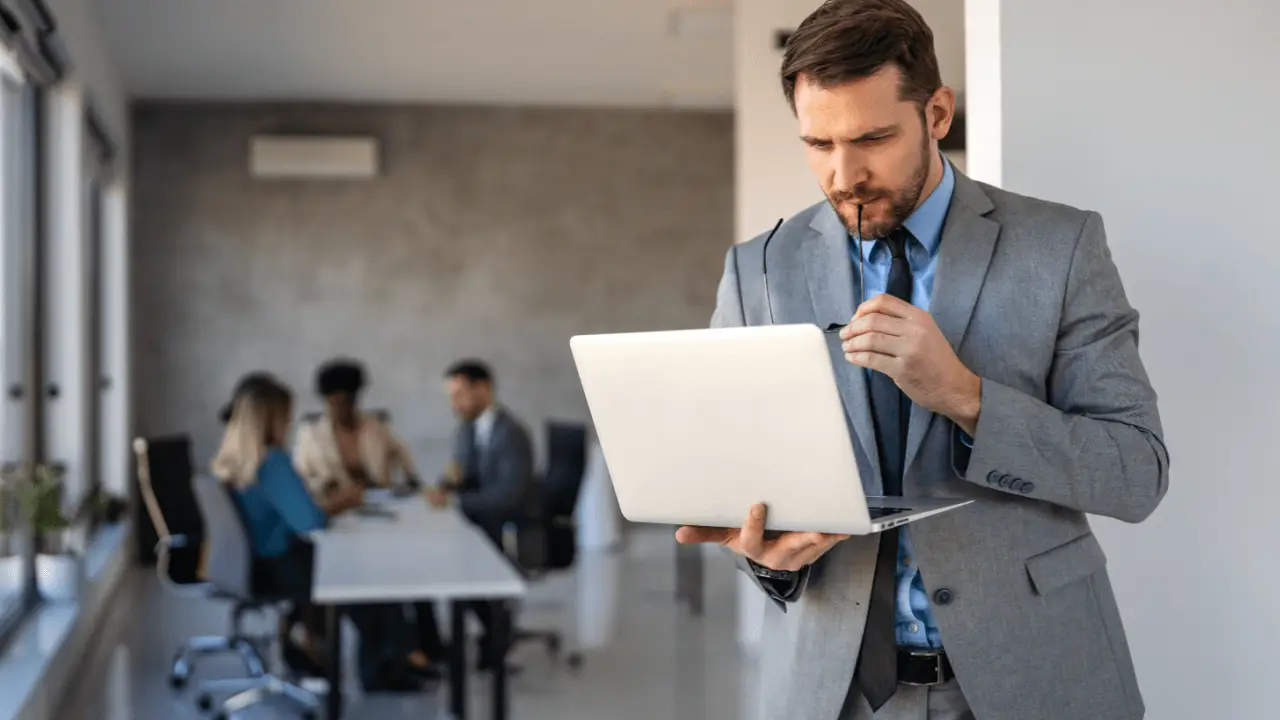 Attorney analyzing conversion optimization for law firms data on laptop in professional office setting