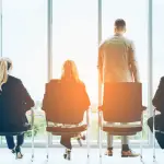 Law firm growth through SEO concept with business professionals looking toward future opportunities through office windows