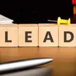 Legal lead generation SEO concept with LEAD wooden blocks on attorney desk with calendar and files