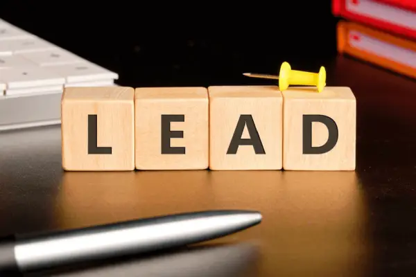 Legal lead generation SEO concept with LEAD wooden blocks on attorney desk with calendar and files