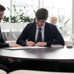 Two attorneys reviewing organic vs PPC legal leads marketing strategies in modern law firm office