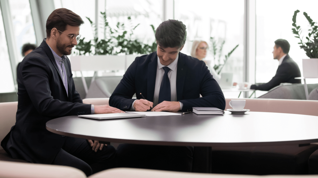 Two attorneys reviewing organic vs PPC legal leads marketing strategies in modern law firm office