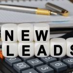 SEO for legal leads concept with new leads text on calculator and money representing law firm client acquisition