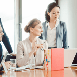 Legal marketing team discussing strategies to turn website traffic into legal leads during conference meeting